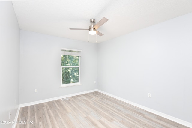 empty room with light hardwood / wood-style flooring, ceiling fan, and a textured ceiling