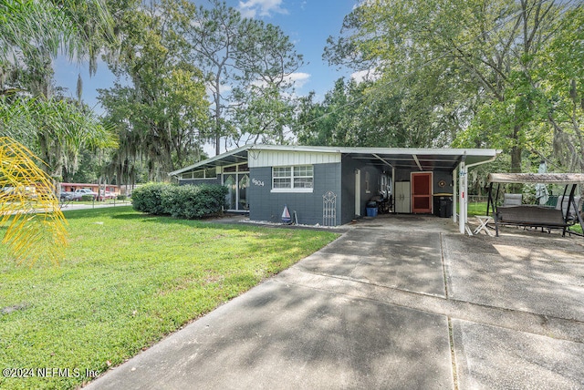 view of front facade with a carport and a front yard