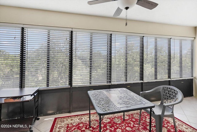 tiled dining space with ceiling fan