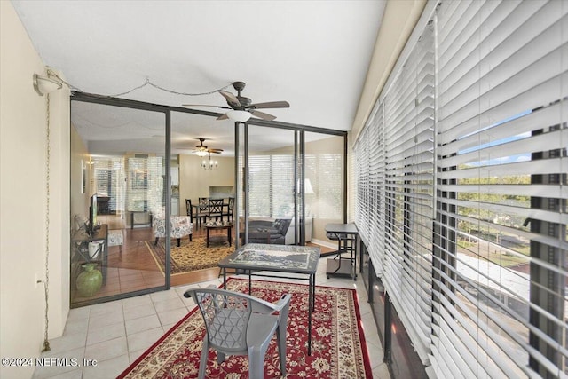 sunroom featuring ceiling fan