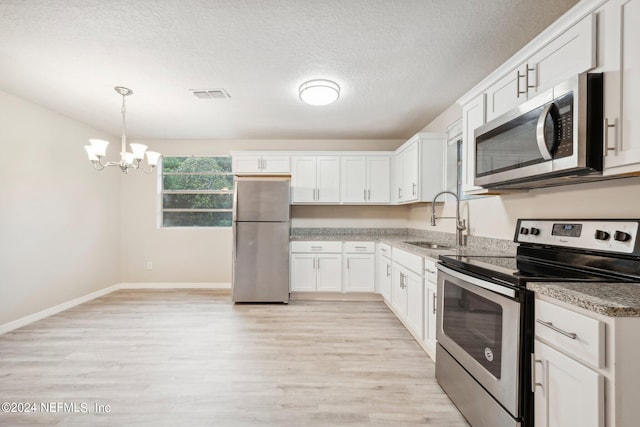 kitchen featuring sink, white cabinetry, light hardwood / wood-style flooring, and stainless steel appliances