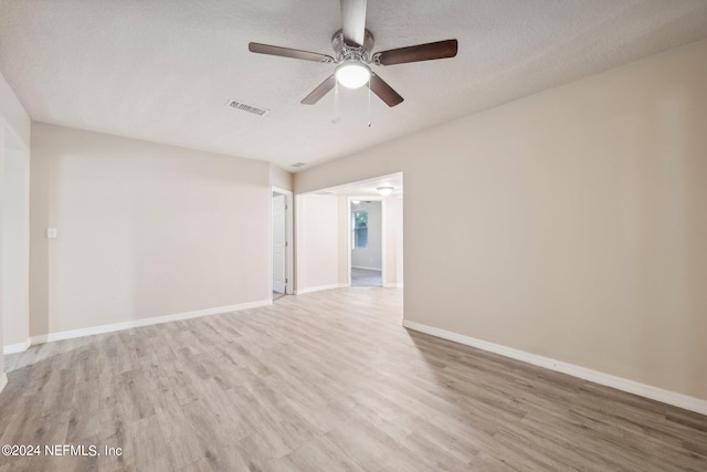 unfurnished room featuring ceiling fan, a textured ceiling, and light hardwood / wood-style flooring