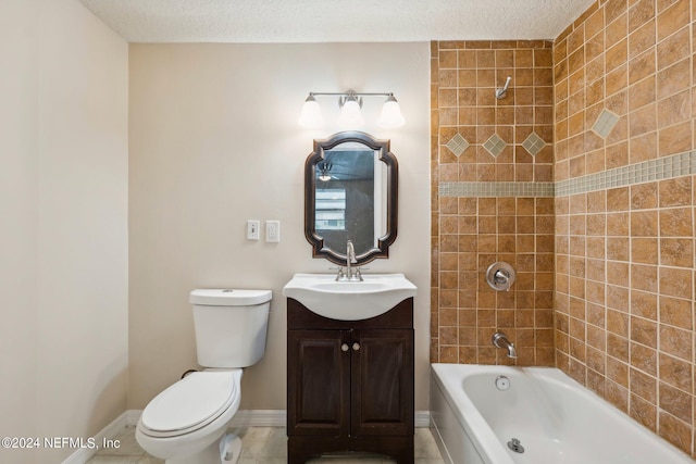 full bathroom with tile patterned floors, toilet, tiled shower / bath, vanity, and a textured ceiling