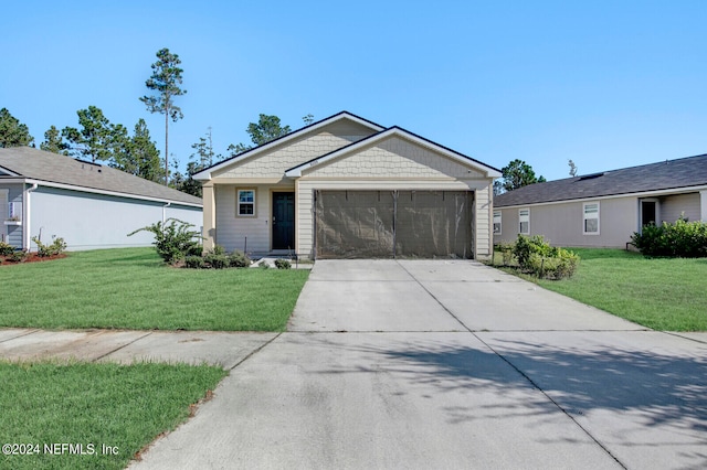 single story home featuring a garage and a front lawn