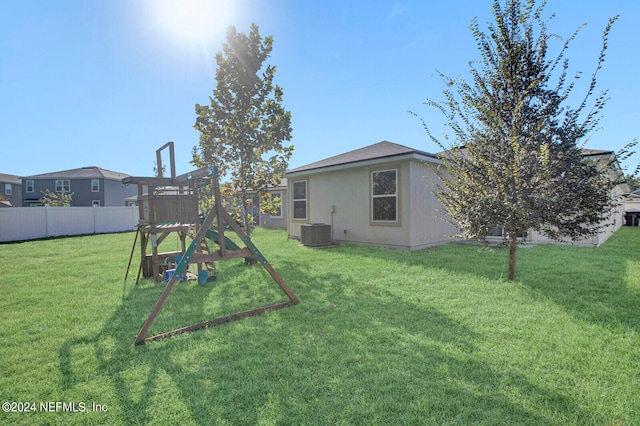 view of yard with a playground and central air condition unit