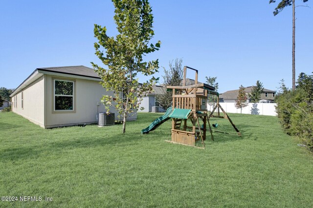 view of play area featuring a yard and central air condition unit