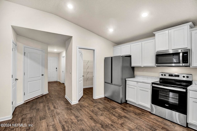 kitchen featuring white cabinets, lofted ceiling, and stainless steel appliances