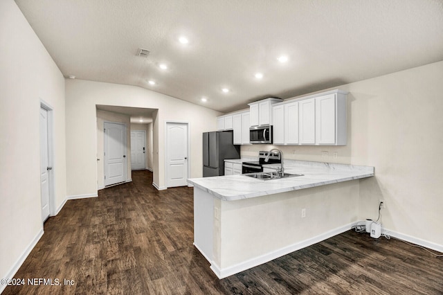 kitchen featuring sink, kitchen peninsula, lofted ceiling, white cabinets, and appliances with stainless steel finishes