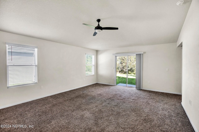 carpeted spare room with ceiling fan and a textured ceiling