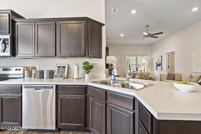 kitchen featuring ceiling fan, sink, kitchen peninsula, stainless steel appliances, and dark hardwood / wood-style floors