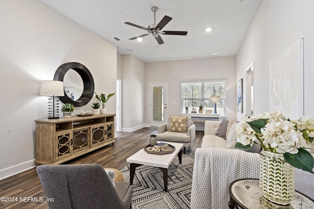 living room with ceiling fan and dark wood-type flooring