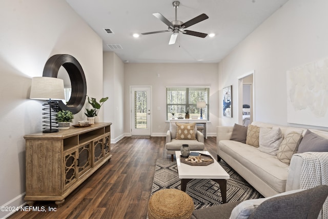 living room with ceiling fan and dark wood-type flooring