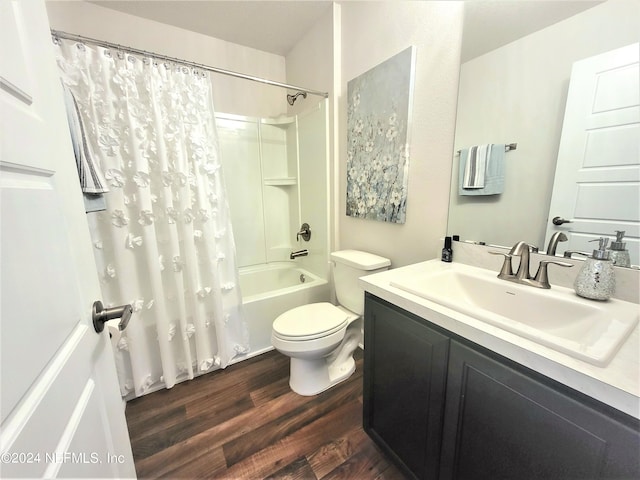 full bathroom with shower / bath combination with curtain, hardwood / wood-style floors, vanity, and toilet