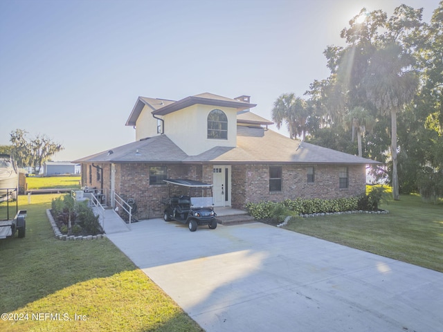 view of front facade with a front yard and a carport