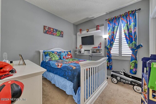 carpeted bedroom with a textured ceiling