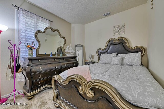 bedroom featuring carpet floors and a textured ceiling