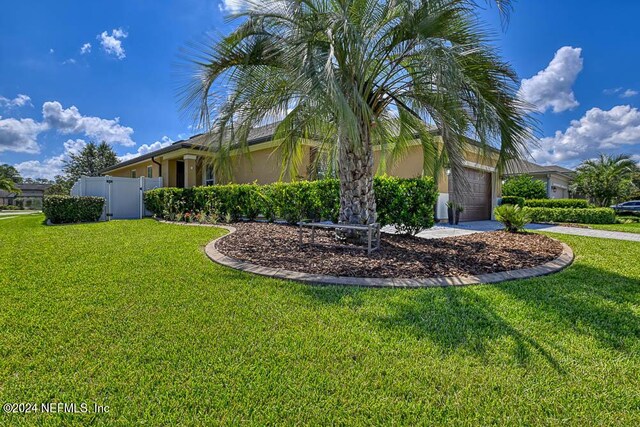 exterior space featuring a lawn and a garage