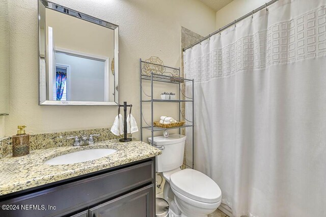 bathroom with vanity, toilet, and a shower with shower curtain