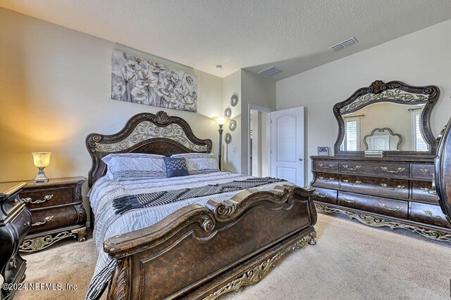 bedroom featuring a textured ceiling and carpet floors