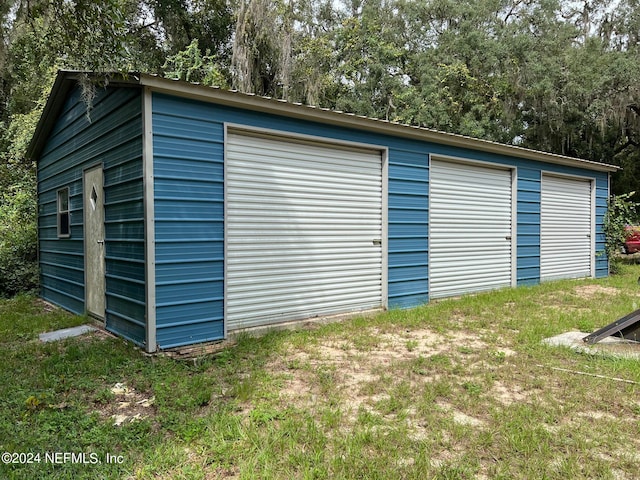 garage featuring a yard