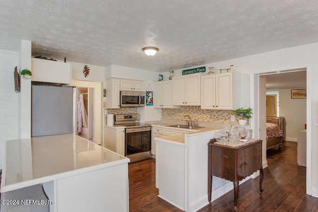 kitchen with a kitchen breakfast bar, appliances with stainless steel finishes, kitchen peninsula, and dark hardwood / wood-style floors