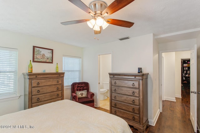 bedroom featuring dark wood-type flooring, connected bathroom, and ceiling fan