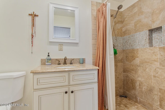 bathroom featuring toilet, walk in shower, and vanity