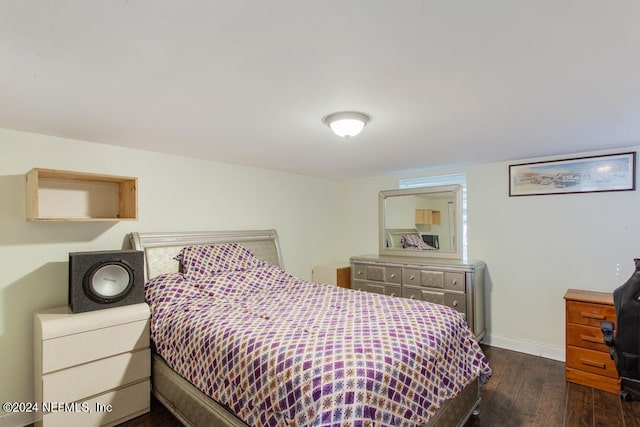 bedroom with dark wood-type flooring