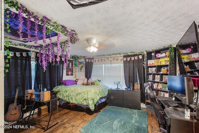 bedroom featuring ceiling fan, a textured ceiling, and hardwood / wood-style flooring