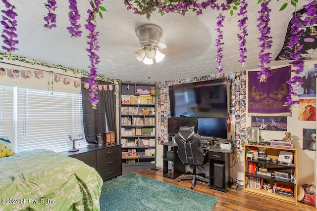 bedroom featuring hardwood / wood-style floors and a textured ceiling