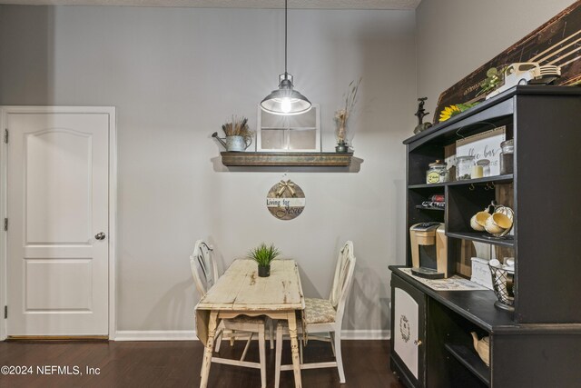 dining space with dark hardwood / wood-style flooring