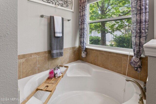 bathroom with tiled tub