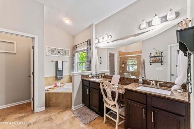 bathroom featuring a textured ceiling, vanity, plus walk in shower, and vaulted ceiling