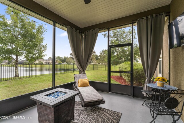 sunroom / solarium with plenty of natural light and a water view