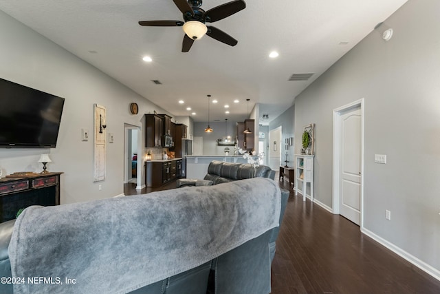 living room with ceiling fan and dark wood-type flooring