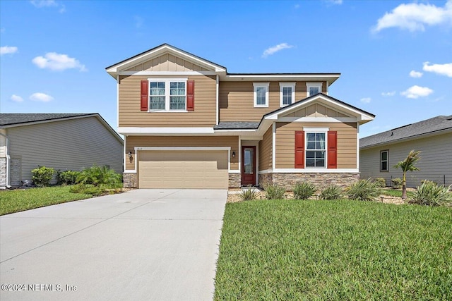 view of front of home featuring a front yard and a garage