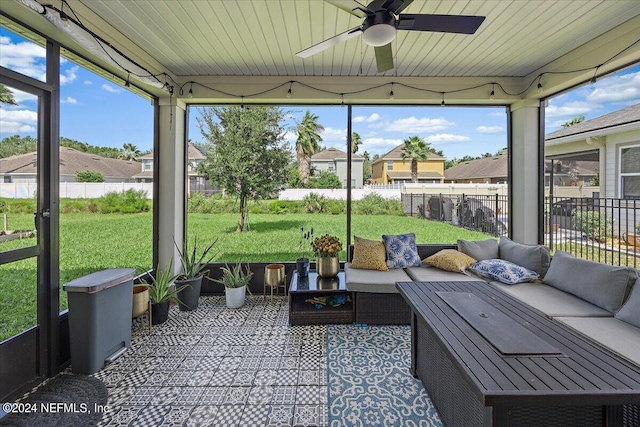 sunroom / solarium featuring ceiling fan