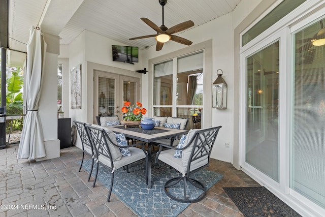 sunroom with french doors, ceiling fan, and wood ceiling