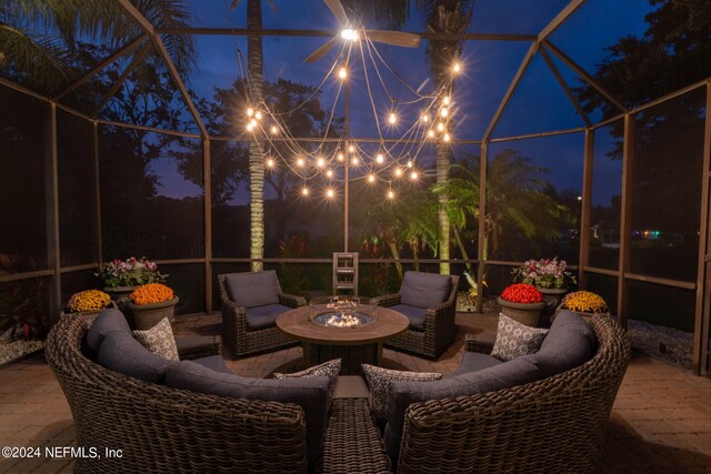 patio at night featuring an outdoor fire pit