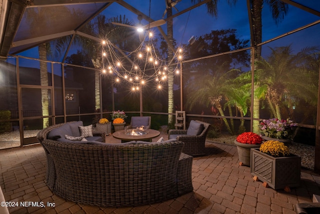 view of patio with outdoor lounge area and glass enclosure