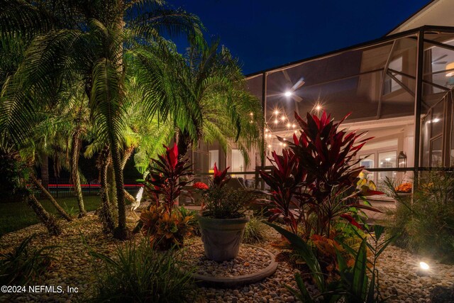 yard at twilight featuring a lanai