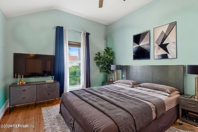 bedroom with wood-type flooring, vaulted ceiling, and ceiling fan