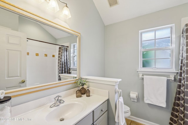 bathroom featuring vanity, a shower with curtain, vaulted ceiling, and toilet