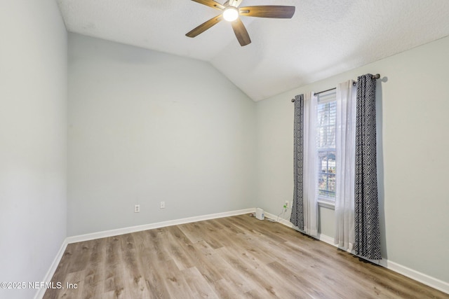 unfurnished room with vaulted ceiling, a textured ceiling, ceiling fan, and light wood-type flooring