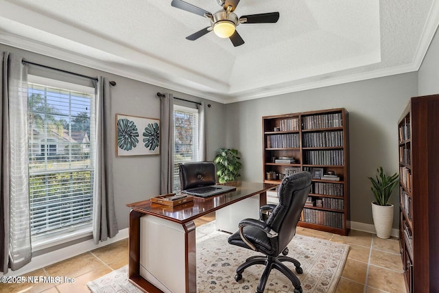 tiled office featuring crown molding, ceiling fan, a healthy amount of sunlight, and a raised ceiling