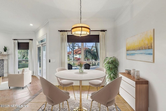 tiled dining area featuring a healthy amount of sunlight, ornamental molding, and a high end fireplace