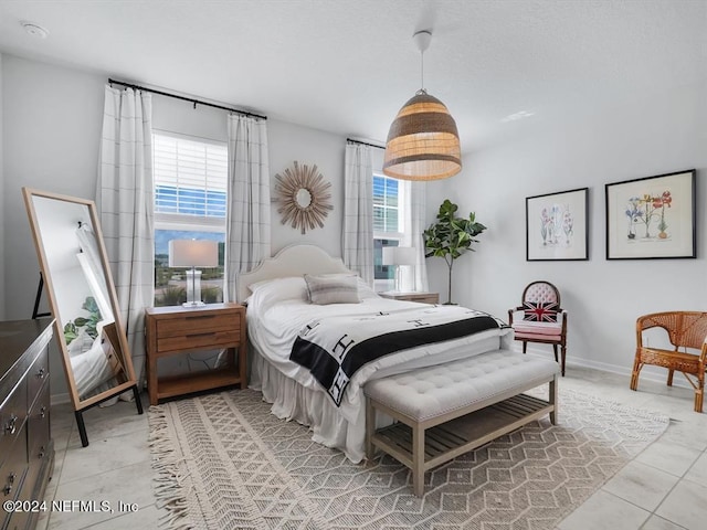 tiled bedroom with multiple windows