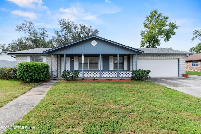 ranch-style house with a front lawn, covered porch, and a garage