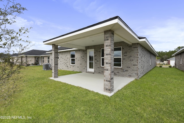 3145 Forest View Ln, Green Cove Springs, FL 32043 - rear view of house featuring a patio, brick siding, and a lawn