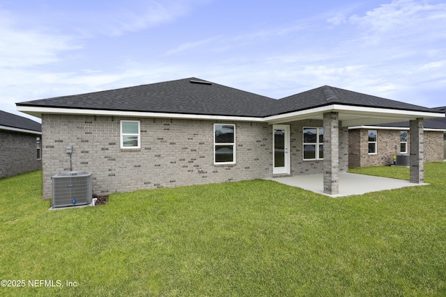 3145 Forest View Ln, Green Cove Springs, FL 32043 - rear view of house featuring a lawn, a patio, brick siding, and roof with shingles